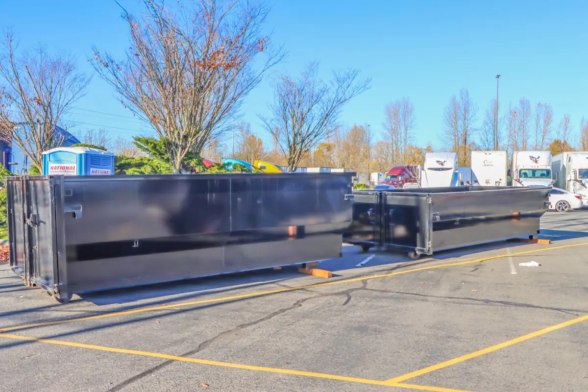Professional dumpster rental service with roll-off container on residential driveway in Aquia Harbour